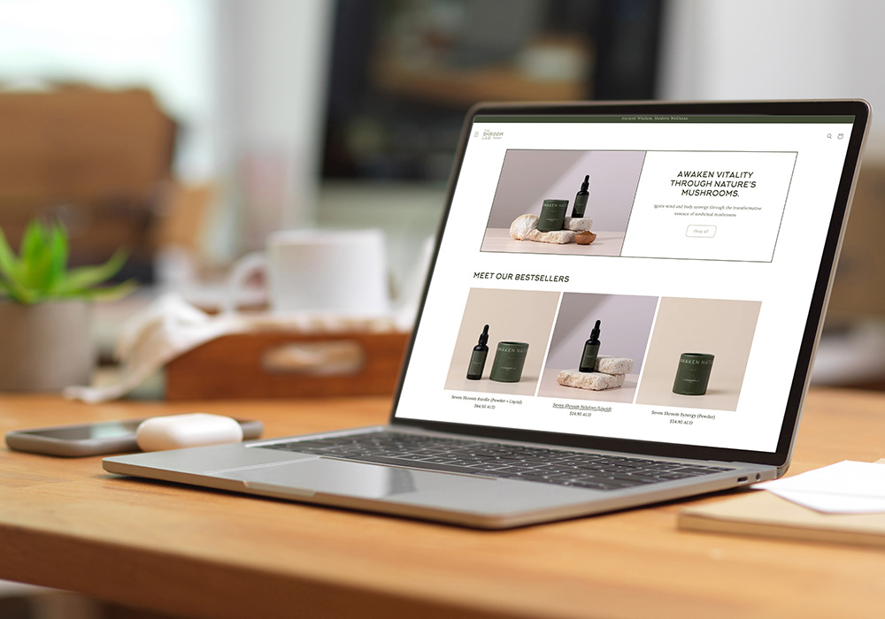 The Shroom Lab eCommerce website and branding portfolio thumbnail showing laptop with online store interface